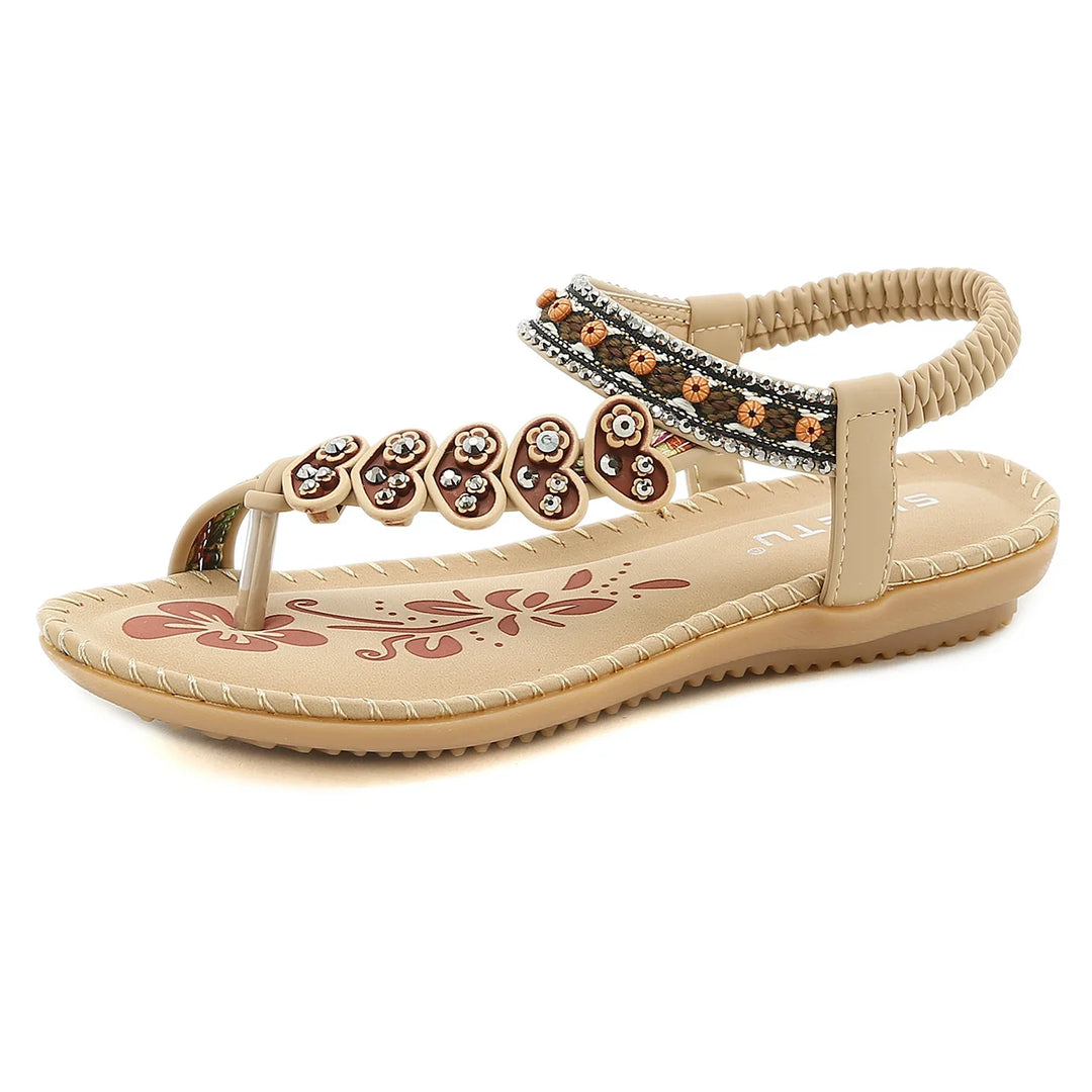 Beige women's flat sandal with floral bead embellishments and elastic back strap