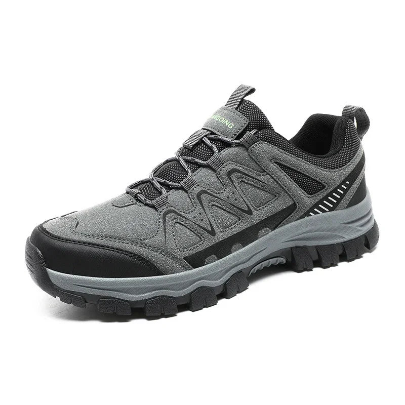 Gray and black hiking shoe with rugged sole and synthetic mesh upper on white background