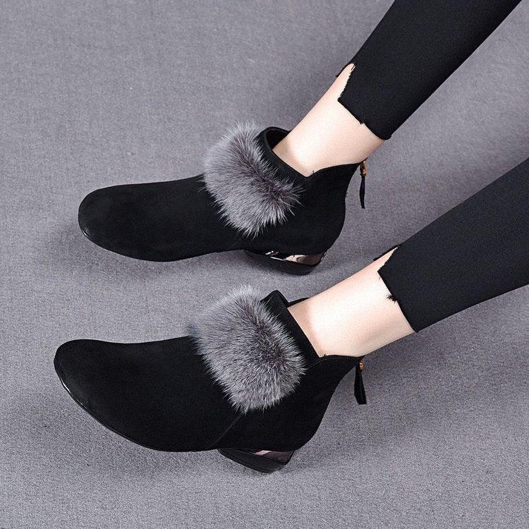 Black suede ankle boots with gray fur trim and gold detail on low heels worn with black leggings