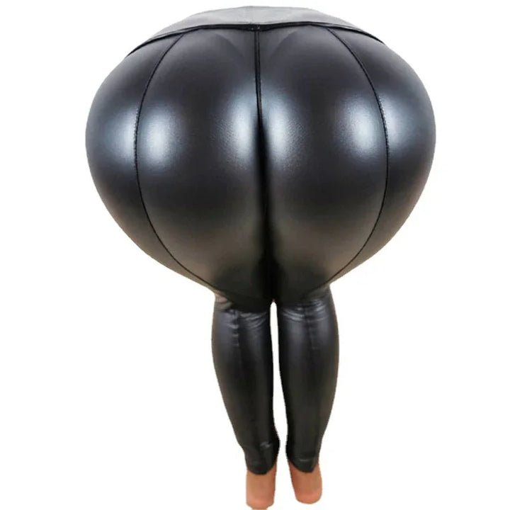 Black shiny faux leather high-waisted leggings with exaggerated padded hips, worn on feet