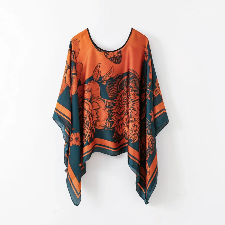 Orange and dark teal floral print poncho with butterfly design, lightweight flowy fabric