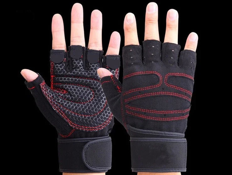 Black fingerless workout gloves with red stitching and wrist straps on hands against black background