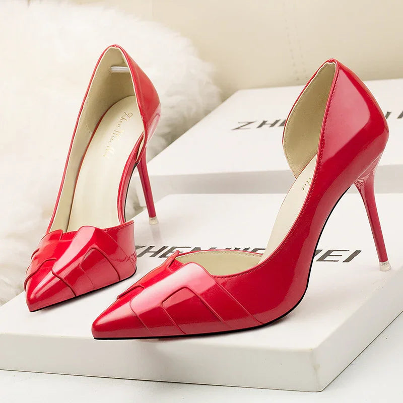 Shiny red high-heeled pointed toe women's shoes on white branded boxes