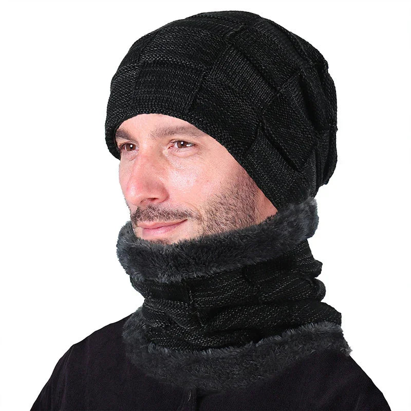 Man wearing black knit beanie and matching fleece-lined neck warmer against white background
