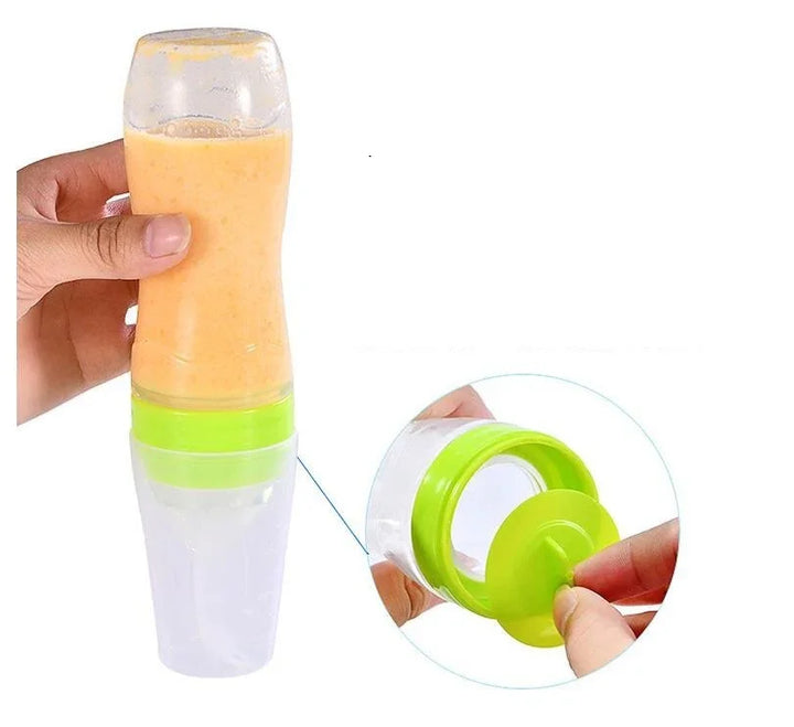 Hand holding a dual-chamber baby food dispenser with orange puree and green seal detail