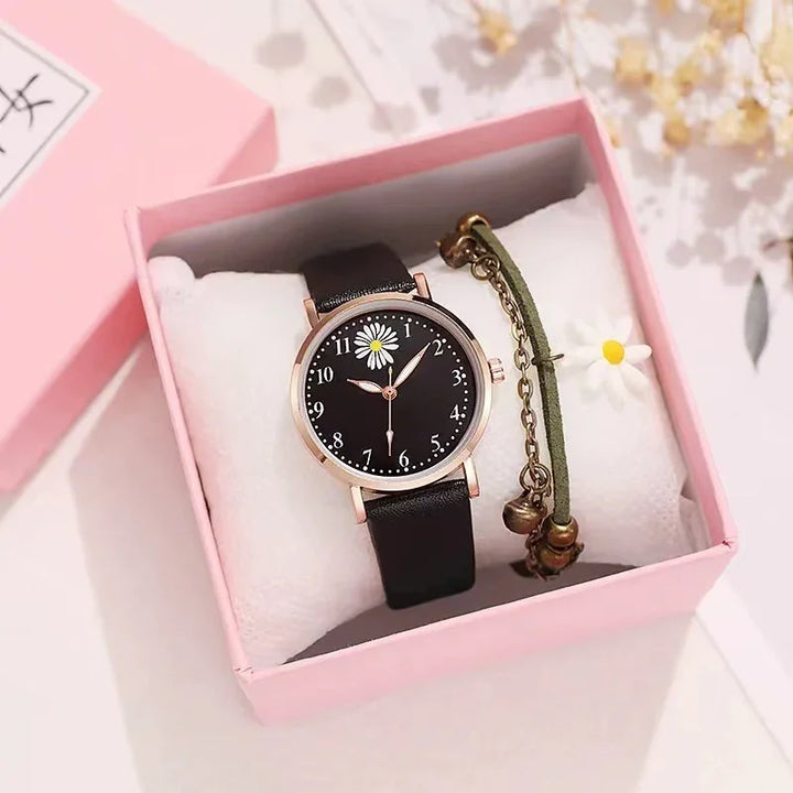 Black leather wristwatch with daisy flower on dial in pink gift box with green bracelet