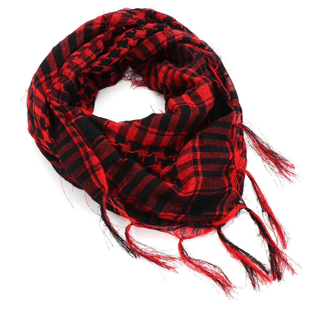 Red and black checkered scarf with fringe edges on a white background