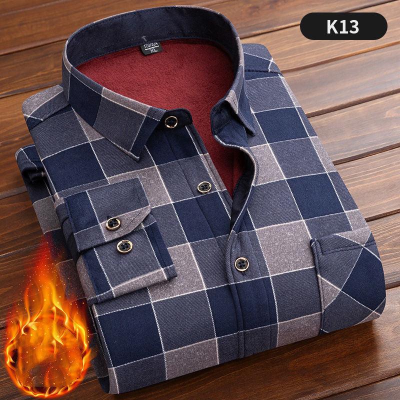 Folded blue and grey checkered flannel shirt with red fleece lining on wooden surface