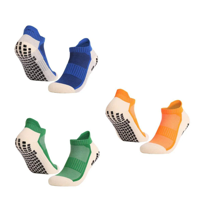 Set of three pairs of non-slip grip socks in blue, green, and orange with white soles and black rubber grips