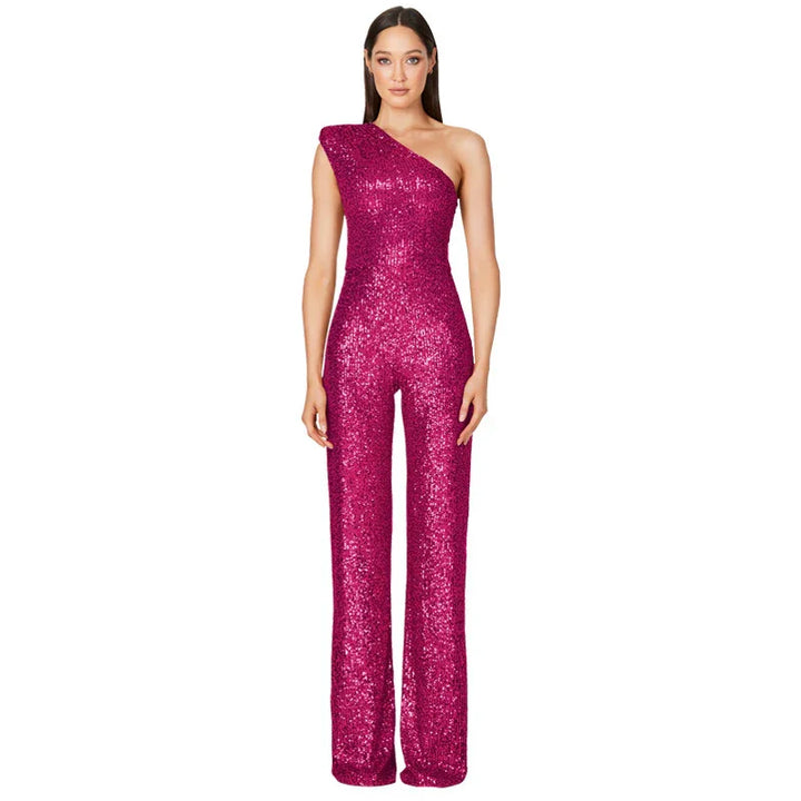 Woman wearing a magenta one-shoulder sequin jumpsuit with wide-leg pants on white background