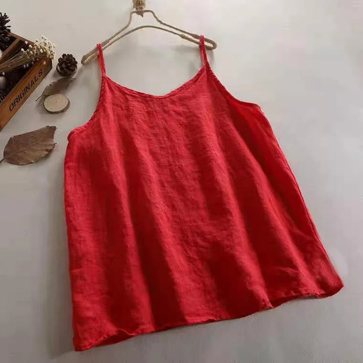 Red sleeveless linen camisole top on hanger with rustic decor