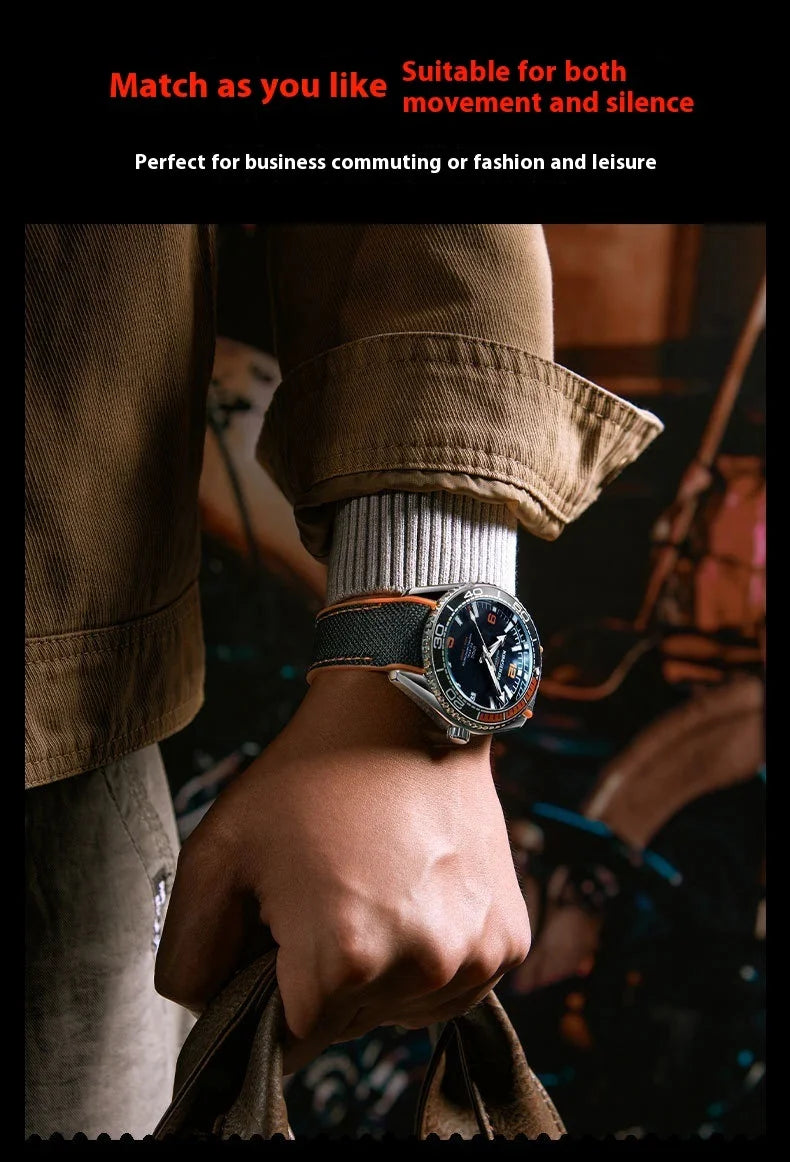 Close-up of wrist wearing black and orange sport watch, styled with casual brown jacket and white cuff