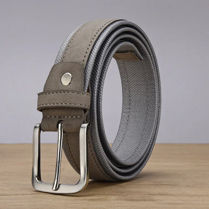 Rolled gray fabric belt with silver metal buckle on wooden surface