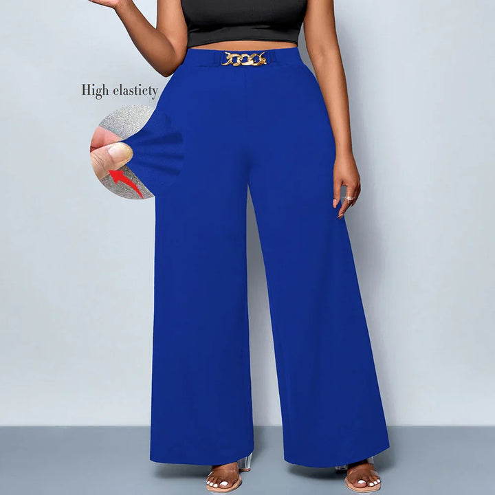 Woman wearing high elasticity royal blue wide-leg pants with gold chain belt and black crop top