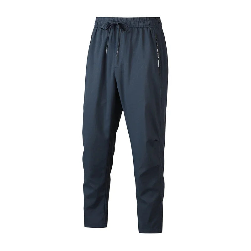 Dark blue lightweight casual pants with elastic waistband, drawstring, and zippered side pocket