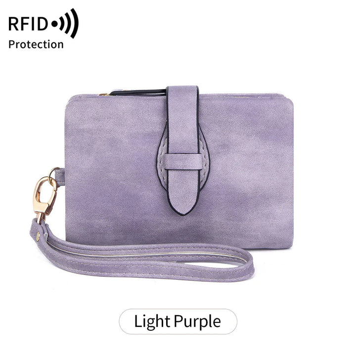 Light purple suede wristlet wallet with strap and RFID protection symbol