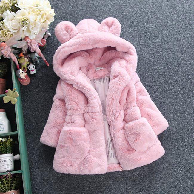 Soft pink plush toddler jacket with hood featuring bear ears on gray background