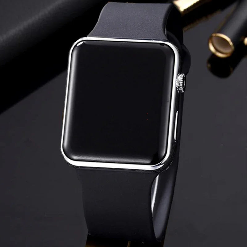 Black smart watch with blank screen and silicone strap on glossy black surface