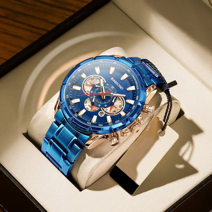 Blue BINBOND men's wristwatch with rose gold accents and tachymeter, displayed on cushioned stand