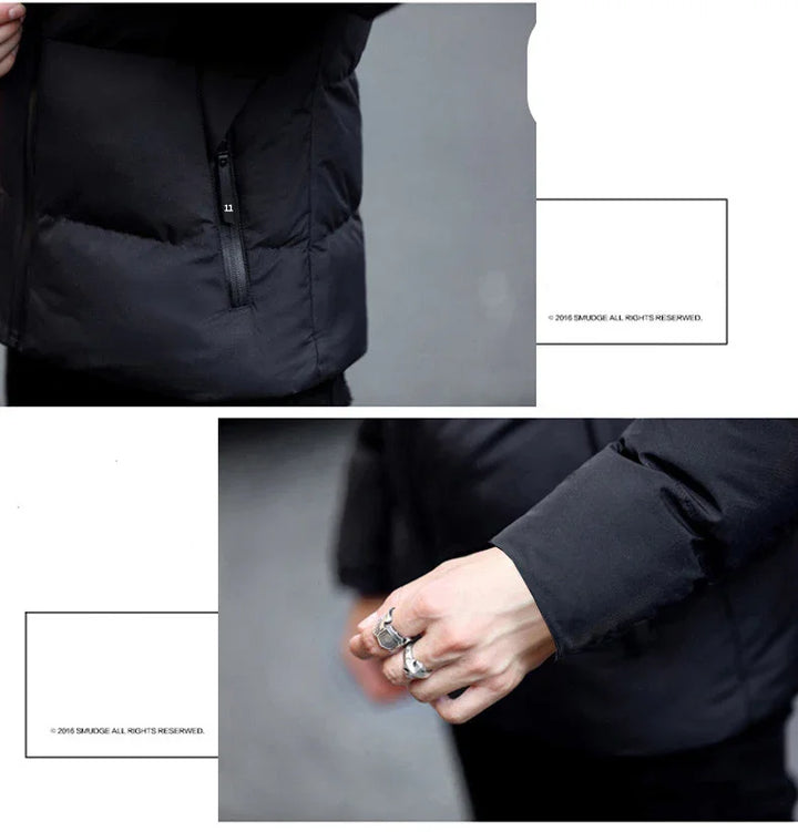 Black puffer jacket close-up showing zipper pocket and sleeve with hand wearing silver rings