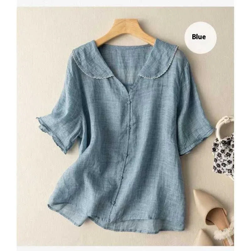 Blue lightweight linen blouse with scalloped collar and buttons, styled with floral bag and beige heels