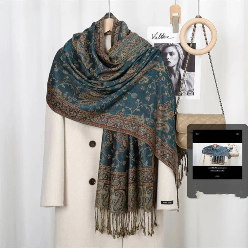 Beige coat with blue paisley patterned shawl draped over, hanging beside beige quilted handbag and black-and-white photo