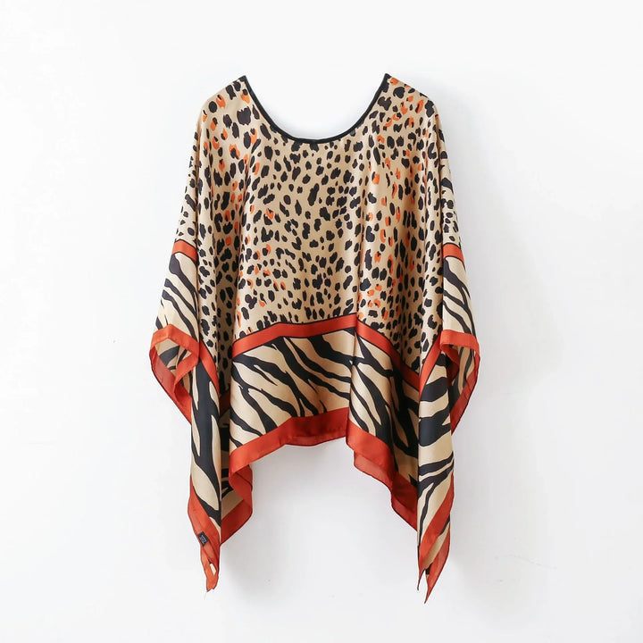 Animal print silk poncho with leopard and zebra patterns and rust orange trim