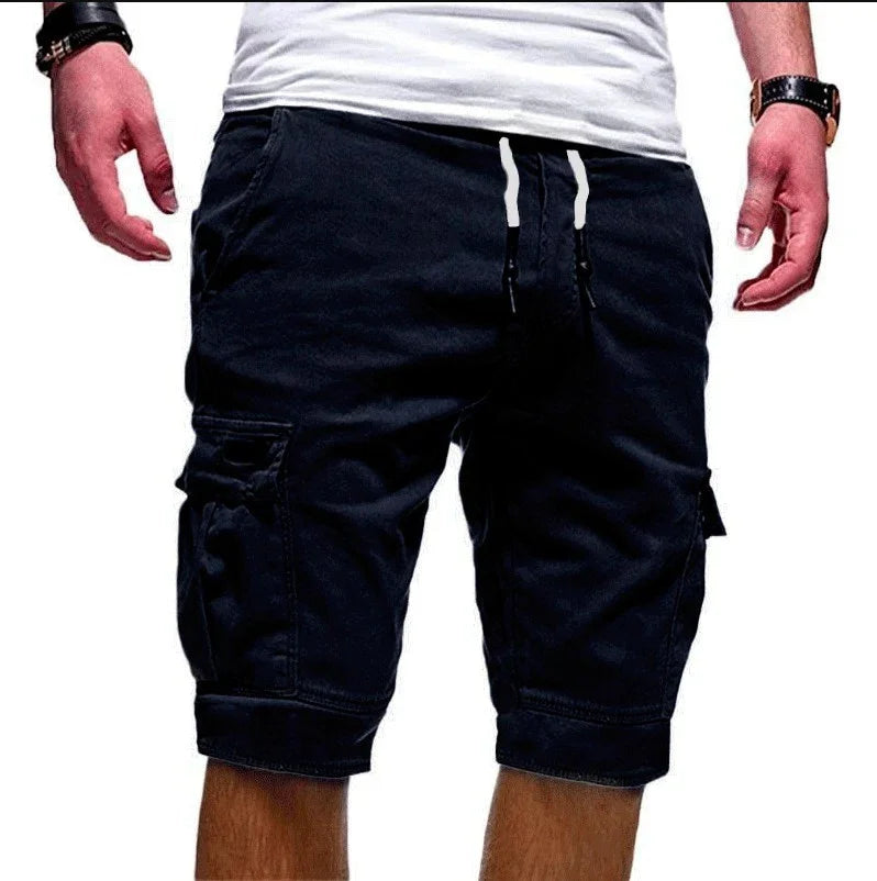 Man wearing black cargo shorts with drawstring waist and side pockets, paired with white t-shirt