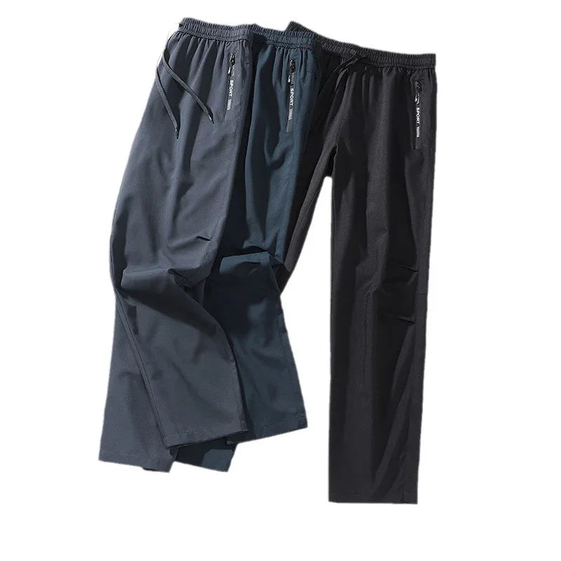 Two pairs of casual men's sport pants in navy blue and black with elastic waist and zippered pockets