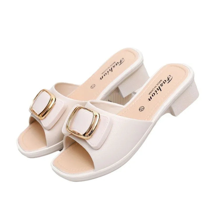 White open-toe women's heeled sandals with gold buckle detail and low block heel