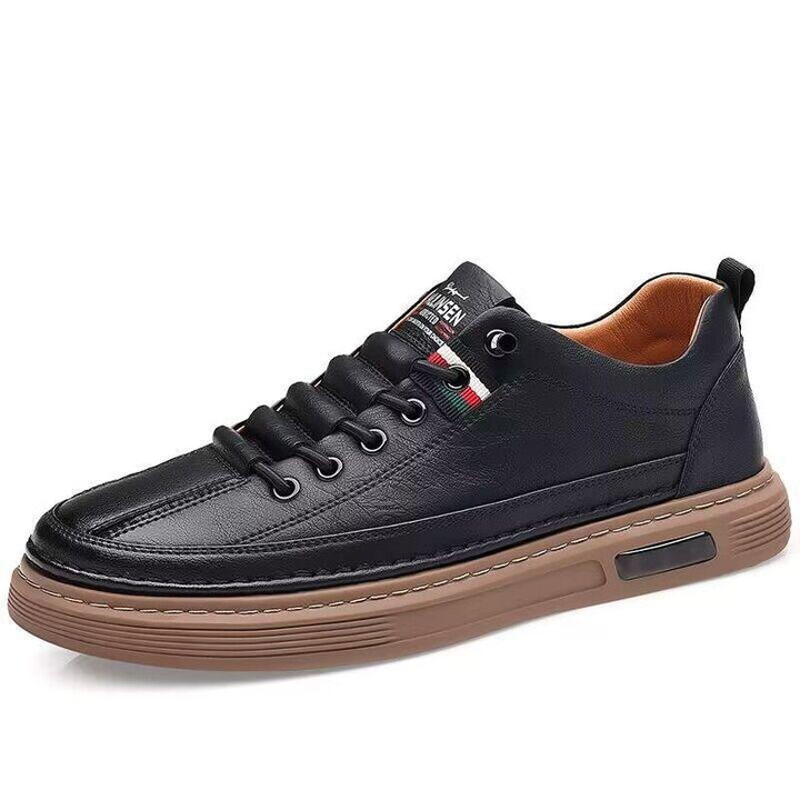 Black leather casual sneaker with brown rubber sole and stitched detailing