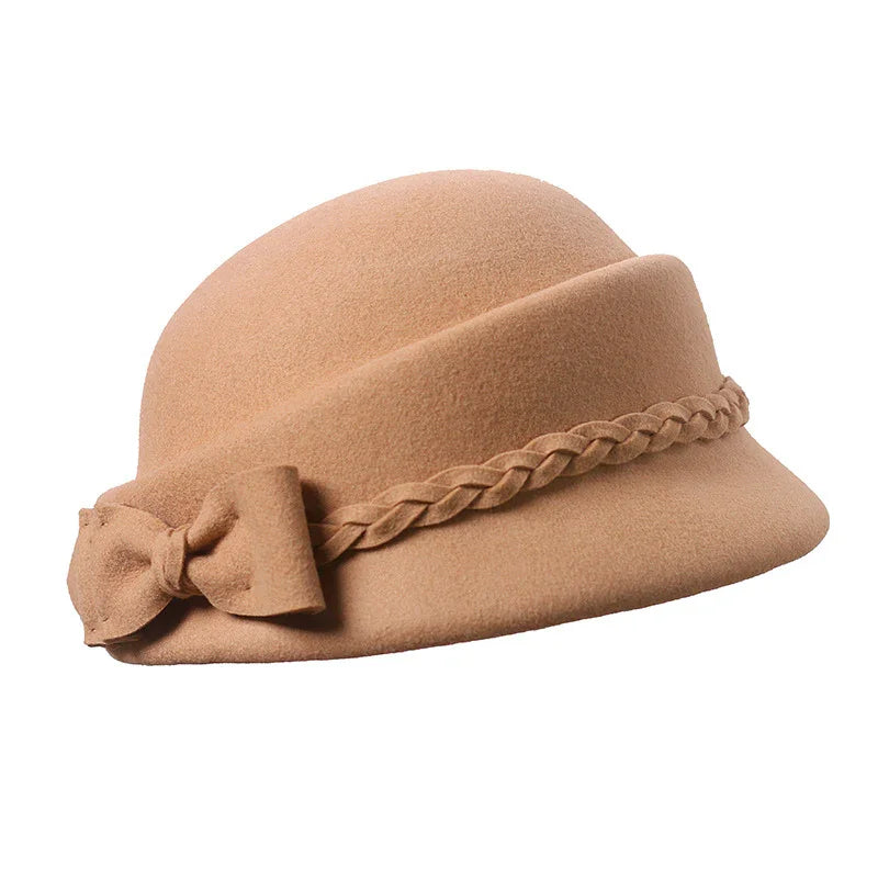 Beige felt cloche hat with braided band and bow detail on white background