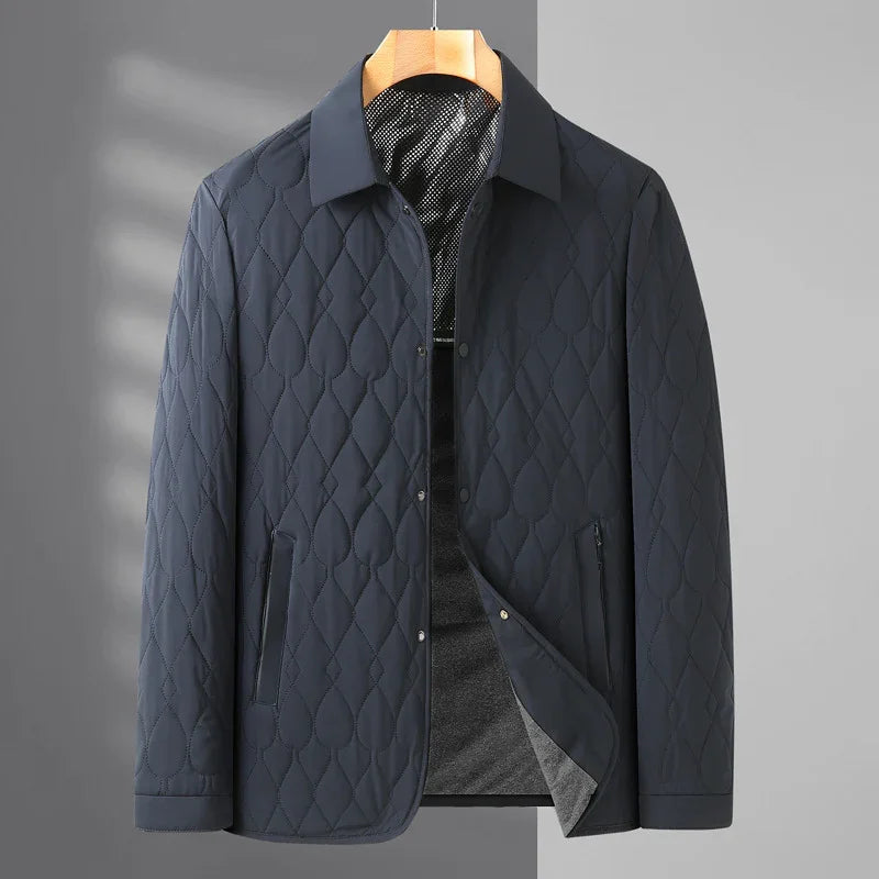 Men's dark blue quilted lightweight jacket with collar and zippered pockets on hanger