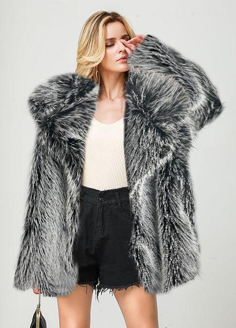 Blonde woman wearing a black and white faux fur coat over beige top and black shorts on white background