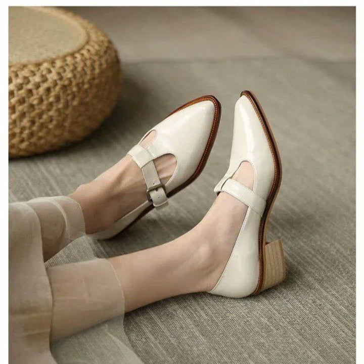 Women's cream leather block heel shoes with buckle strap on grey carpet