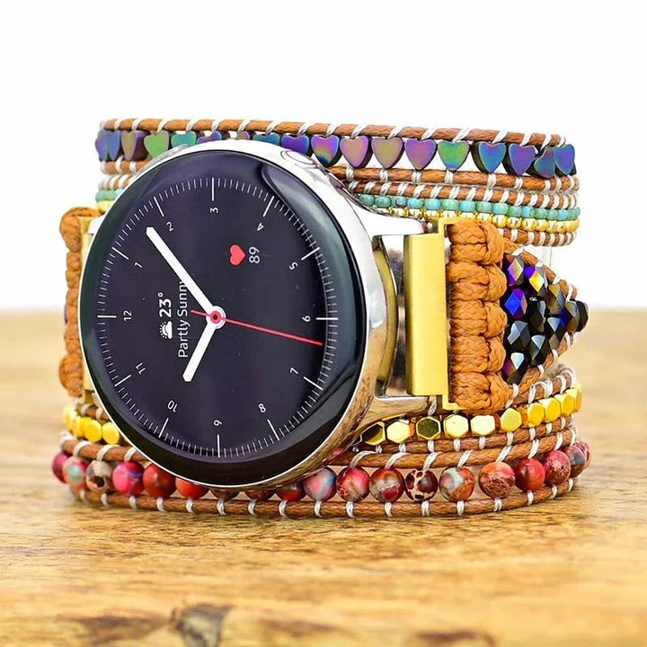 Smartwatch with colorful beaded and woven leather wrap bracelet on wooden surface