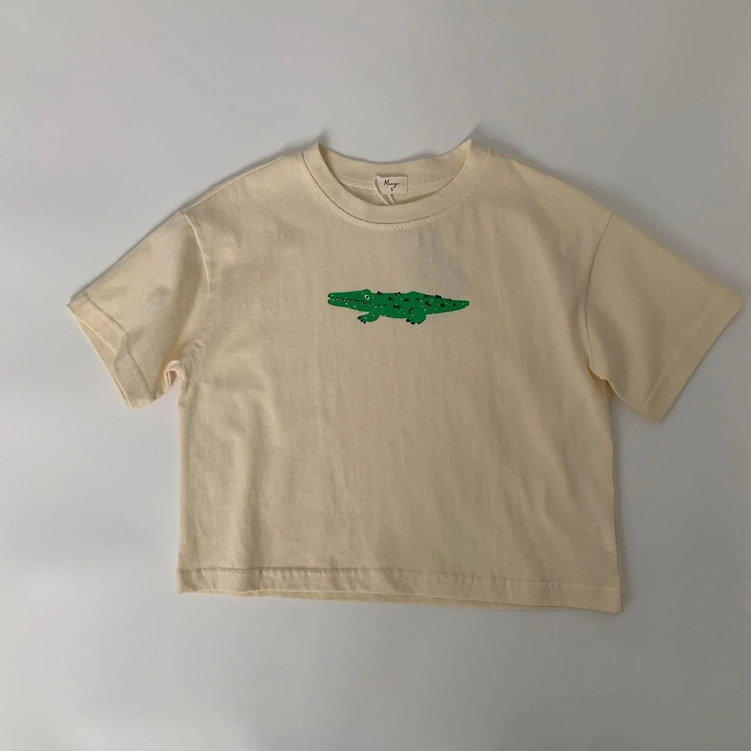 Beige short-sleeve kids t-shirt with a green cartoon crocodile graphic in the center