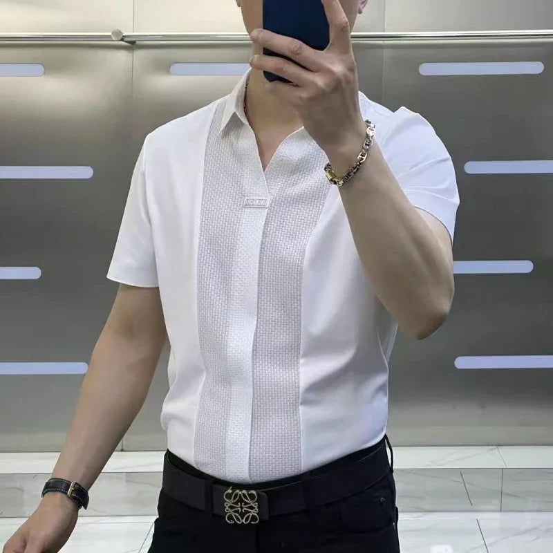 Man wearing white short-sleeve shirt with textured front panel, black belt, and bracelet taking mirror selfie