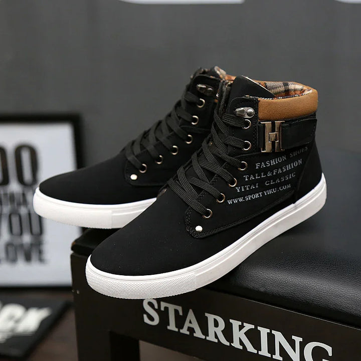 Black high-top fashion sneakers with white soles, brown padded collar, and printed text on side