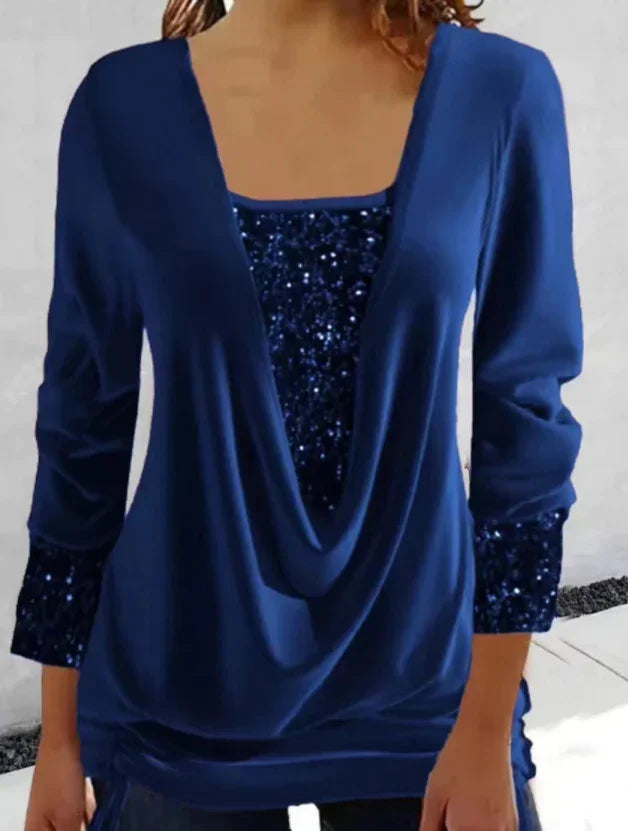 woman wearing navy blue cowl neck top with sequined panel and cuffs in casual setting