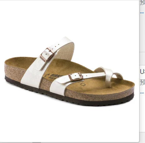 White Birkenstock sandal with cork footbed and adjustable buckle straps on white background