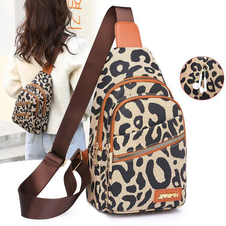 Leopard print crossbody sling bag with brown adjustable strap and multiple zippered compartments