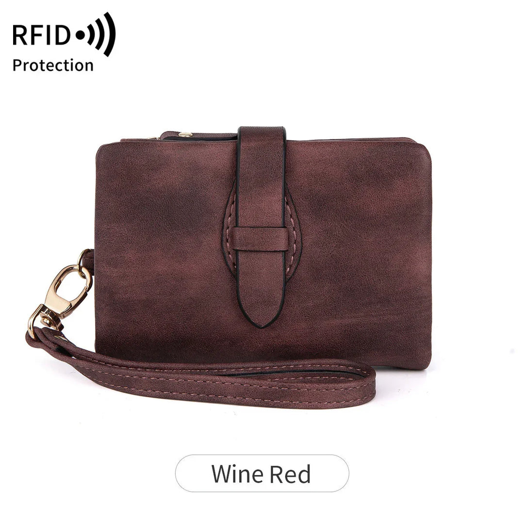 Wine red leather RFID protection wristlet wallet with strap and buckle detail
