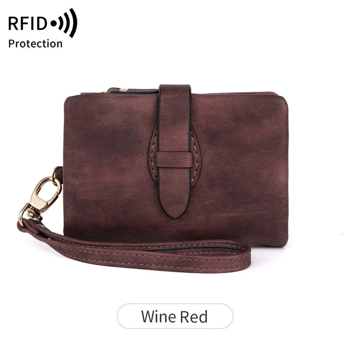 Wine red leather RFID protection wristlet wallet with strap and buckle detail