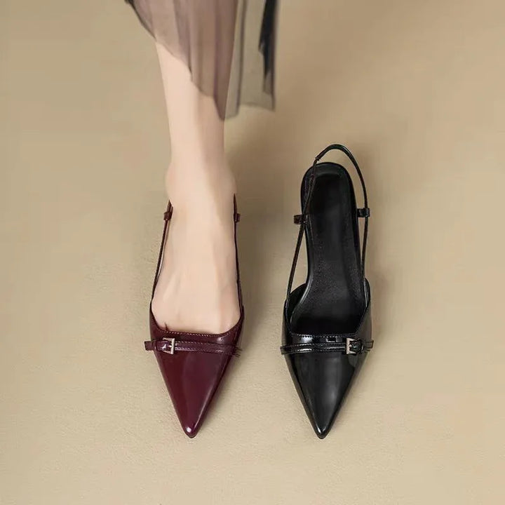 Women’s pointed toe slingback flats in burgundy and black leather on beige background