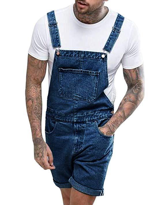 Man wearing tattooed arms white t-shirt and blue denim short overalls with front pocket