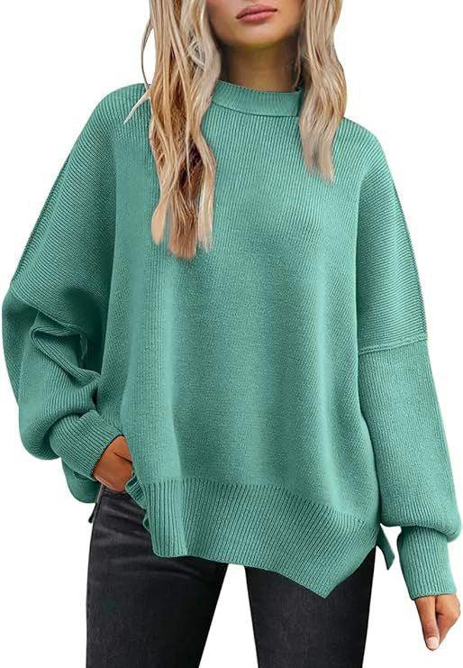 Woman wearing oversized mint green knit sweater with drop shoulders and long sleeves