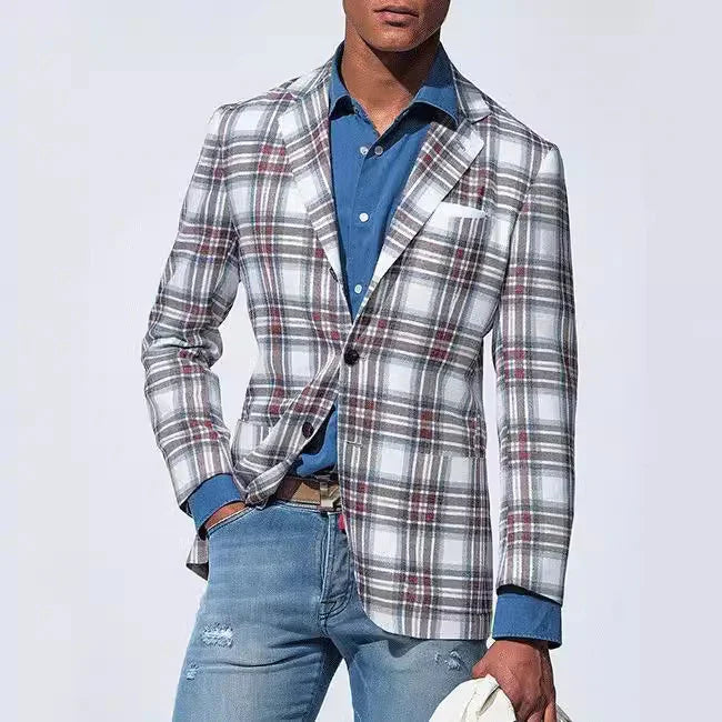 Man wearing a white and gray plaid blazer over a blue shirt with ripped blue jeans holding a white hat