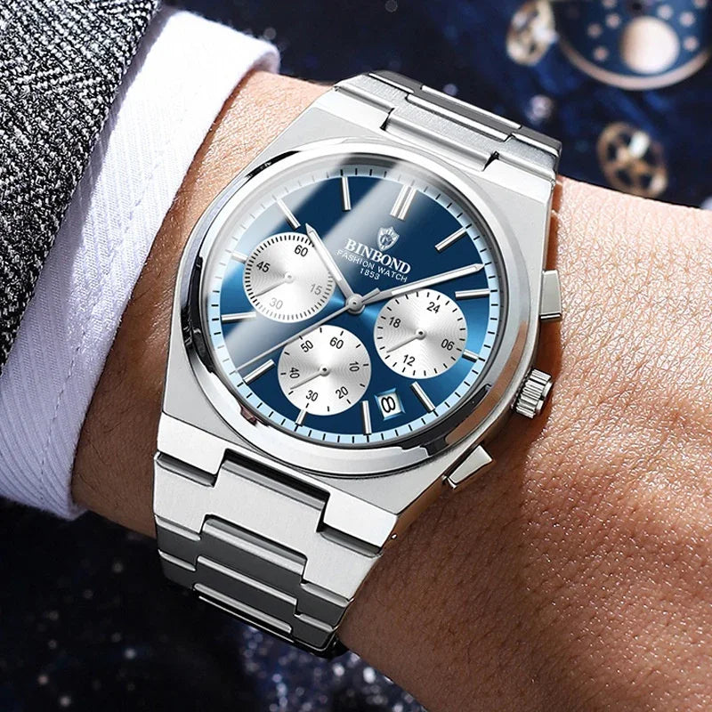 Close-up of a silver BINBOND chronograph wristwatch with blue dial and metal bracelet on a man's wrist