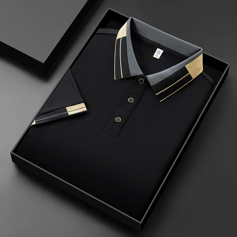 Black polo shirt with gray and beige geometric collar and sleeve cuff, neatly folded in a black gift box